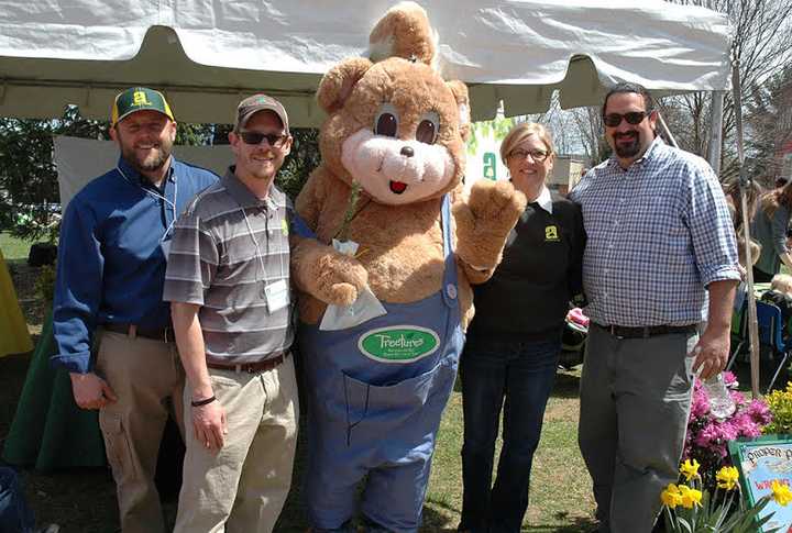 The Almstead team, left, Jon Olsz, arborist; Ryan Duff, arborist; Patti Balliet, office manager; Mike Almstead, vice president, at the recent Earth Day celebrations.