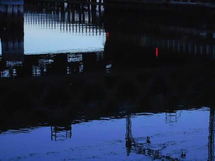 The bridge is reflected in the Norwalk River. 