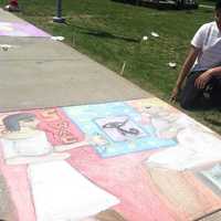 <p>Enrique Silva, left, 20, from Fairfield, and Johan Silva, 19, Bridgeport looking at the work they created at the Sidewalk Arts Festival.</p>