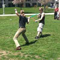 <p>Students engaged in sword play at the Sidewalk Arts Festival.</p>