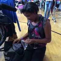 <p>A teen girl checks out some of the items at the boutique.</p>