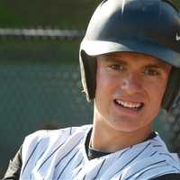 <p>A Mamaroneck players gets loose in the on-deck circle.</p>