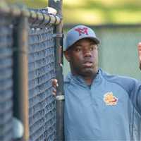 <p>Knights Manager Ernie Richardson gives signs from the dugout. </p>