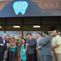 <p>Danbury Mayor Mark Boughton cuts the ribbon at the grand opening for All About Kids dentistry on West Street. </p>