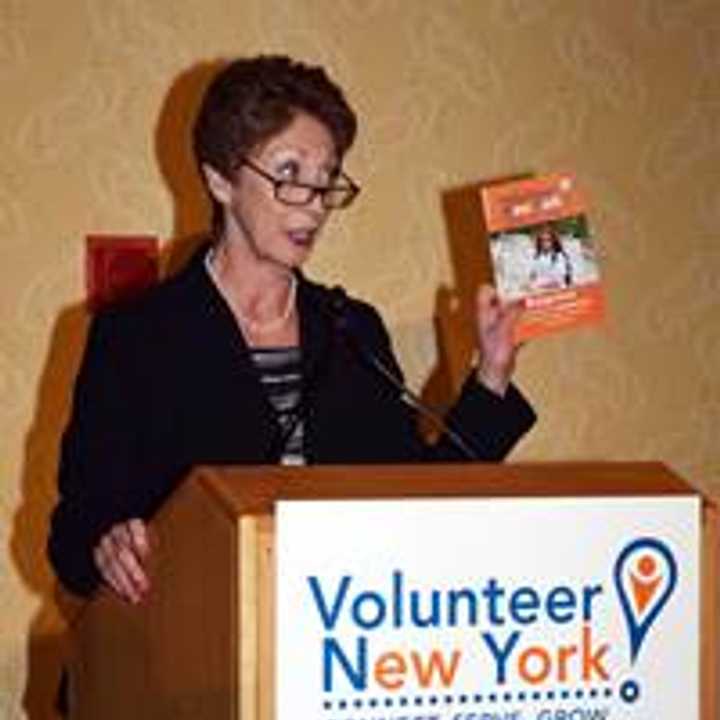 Presenter Paula Mandell showcasing the Volunteer New York! Orange Book, a volunteerism guidebook, at the recent Volunteer Spirit Awards in Tarrytown.