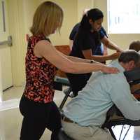 <p>Students giving massages at the fifth anniversary party for Ridley-Lowell in Danbury. </p>