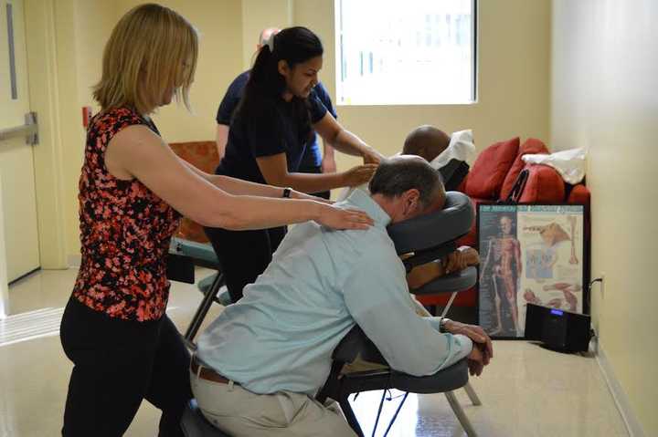 Students giving massages at the fifth anniversary party for Ridley-Lowell in Danbury. 