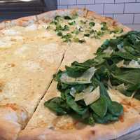 <p>Popeye&#x27;s White pizza with spinach.</p>