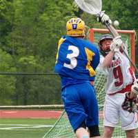 <p>Danny Foley (3) of Mahopac puts a ball in the goal in a 7-6 win over top seed Fox Lane. </p>