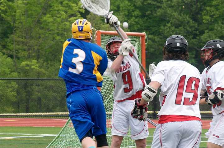 Danny Foley (3) of Mahopac puts a ball in the goal in a 7-6 win over top seed Fox Lane. 