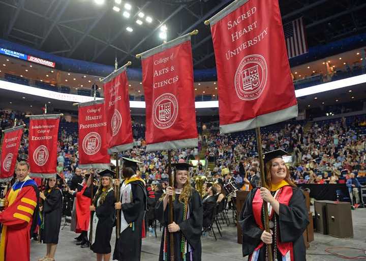 Sacred Heart University celebrates its undergraduate commencement on Sunday, May 17, at the Webster Bank Arena in Bridgeport. Student Government President Nicole Gittleman, right, and Taylor Magnotti are part of the procession. 