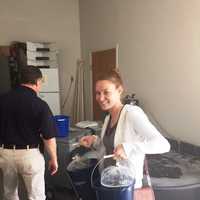 <p>A resident gets her minnows. The minnows will be distributed in watertight plastic bags.</p>