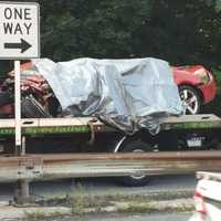 <p>The vehicle involved in the fatal crash is placed on a tow truck in July 2014.</p>