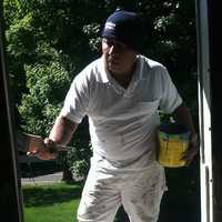 <p>José Ramos paints a second-story window frame at the Hanford-Silliman House before a restored 250-year-old window was to be reinstalled.</p>