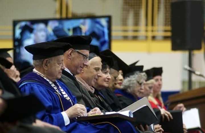 Pace University President Stephen Friedman, left, sits among University faculty at Tuesday&#x27;s ceremony. 