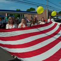 <p>Red, white and blue take center stage, as marchers carry a giant flag at Monday&#x27;s Memorial Day parade in Fairfield.</p>