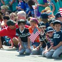 <p>A group of Little Leaguers watches the Memorial Day parade.</p>