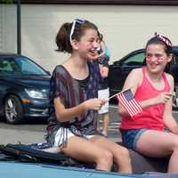 <p>Two girls show their patriotism in the parade.</p>