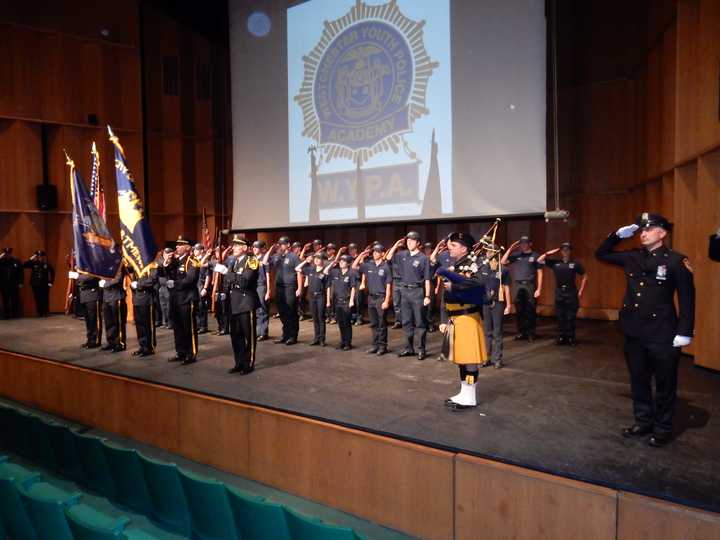 Graduates of the Westchester Youth Police Academy salute during their graduation ceremony in Pleasentville Wednesday afternoon