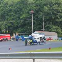 <p>An injured person being loaded into the back of the STAT helicopter</p>