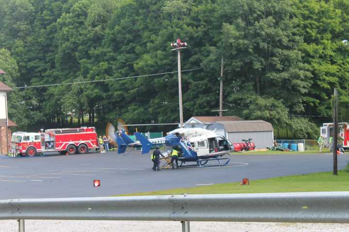 An injured person being loaded into the back of the STAT helicopter