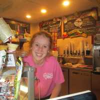 <p>Kelly Sullivan scooping ice cream at Main Street Sweets in Tarrytown</p>