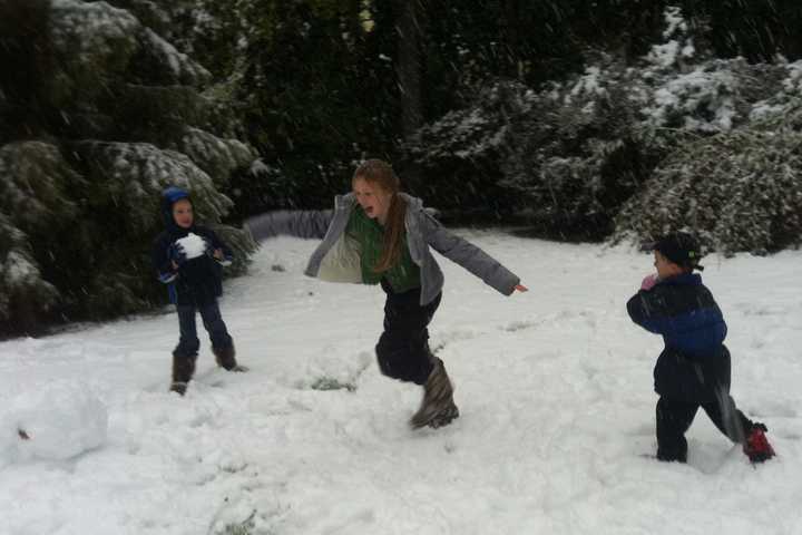 Children play in the snow after the early snowfall on Oct. 29, 2011.