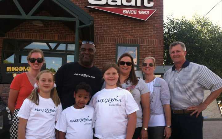 Connor Armstrong, 7, front, with 11-year-old twin sisters, Megan, left, and Alexis, right. In back, from left; Meredith Donaher of Gault Energy, parents John and Melanie Armstrong, Kim Smith, Make-A-Wish, and Sam Gault of Gault Energy.