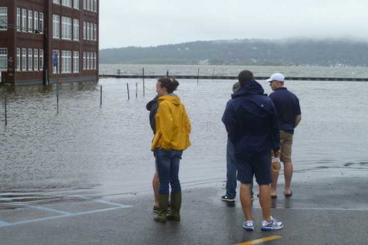 Irvington residents look at flooding in the Bridge Street parking lot after Hurricane Irene caused the Hudson River to overflow.