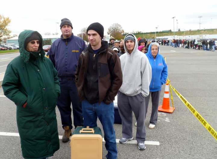 Nathaniel Fasman (right) stands in  line with his mother, Barbara, to get dry ice Wednesday at Empire City Casino in Yonkers.