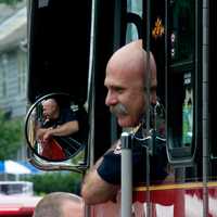 <p>A first responder pops his head out of his truck to say hello to spectators at Sunday&#x27;s Great Street Parade.</p>