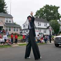 <p>A man on stilts walks in Sunday&#x27;s Great Street Parade.</p>