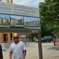 <p>Construction workers pose by the 1 Kennedy Flats apartment development in downtown Danbury. </p>