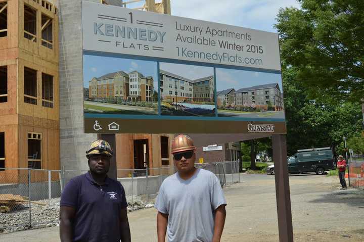 Construction workers pose by the 1 Kennedy Flats apartment development in downtown Danbury. 