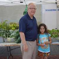 <p>Mayor Mark Boughton poses with a young shopper at the Danbury Farmers Market. </p>