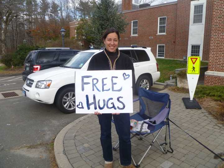 Kiko Teed offered free hugs to passersby near the Easton police station Thursday as residents picked up food and water.