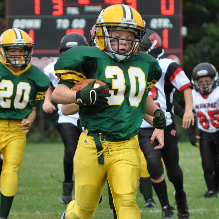 Norwalk&#x27;s Roderick Olson runs for a score during a fourth-grade game earlier this year. The Packers play for the league championship Saturday in Ansonia.