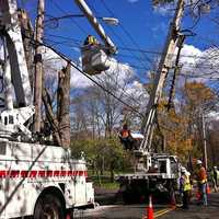 <p>Line crews from all over the country are coming to aid in restoring power to towns like Ridgefield. This crew from Michigan was working on Branchville Road on Friday.</p>