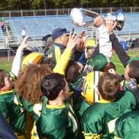 <p>Players on the Norwalk Packers celebrate after Saturday&#x27;s victory over Bridgeport.</p>