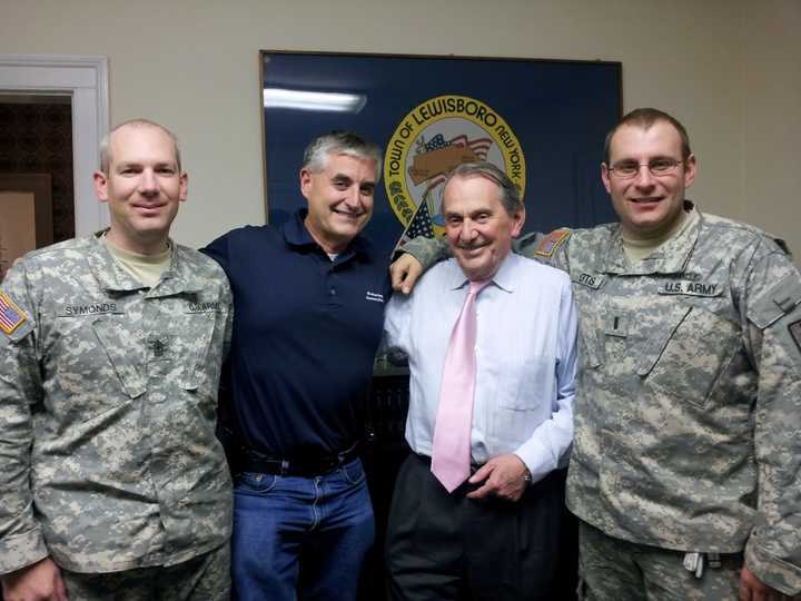 Deputy Supervisor Peter DeLucia, second from left, and Supervisor Peter Parsons, second from right, with two members of the National Guard who arrived Friday to help with the post-Hurricane Sandy clean-up efforts.