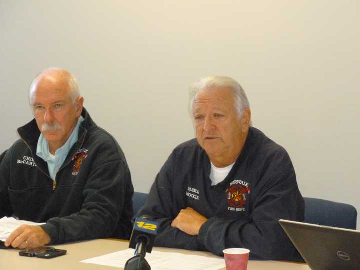 Norwalk Mayor Richard Moccia, right, and Fire Chief Denis McCarthy Sunday discuss the city&#x27;s polling situation following Hurricane Sandy. All Norwalk voting sites will be open at 6 a.m., today, and close at 8 p.m. 