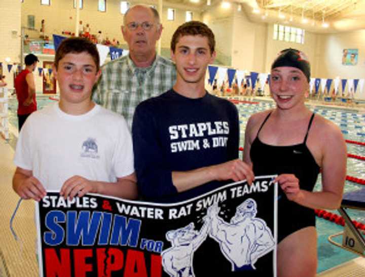 Swimmers Scott Adler, Mark Schachter and Aileen Coyne with Gary Shaye, the senior director of Save the Children.