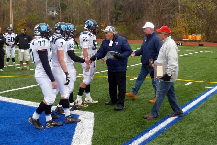 The Rye Neck High School football team receives its runner-up plaque at the Section 1 Class C championship game.