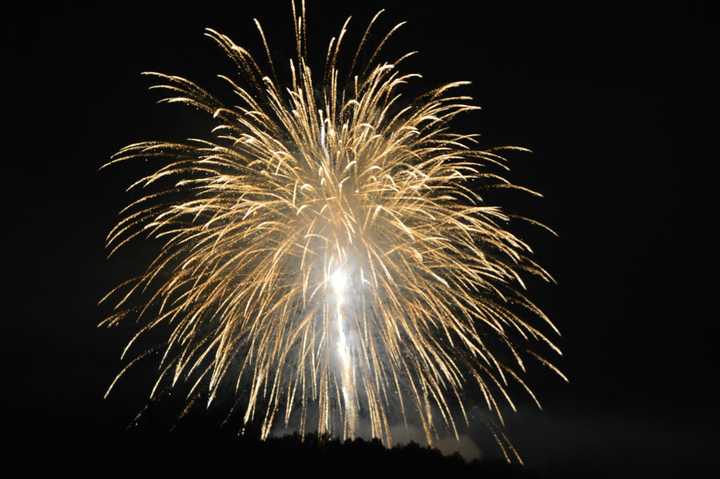 Fireworks explode above the Danbury Fair Mall and Danbury Airport on Thursday evening. 