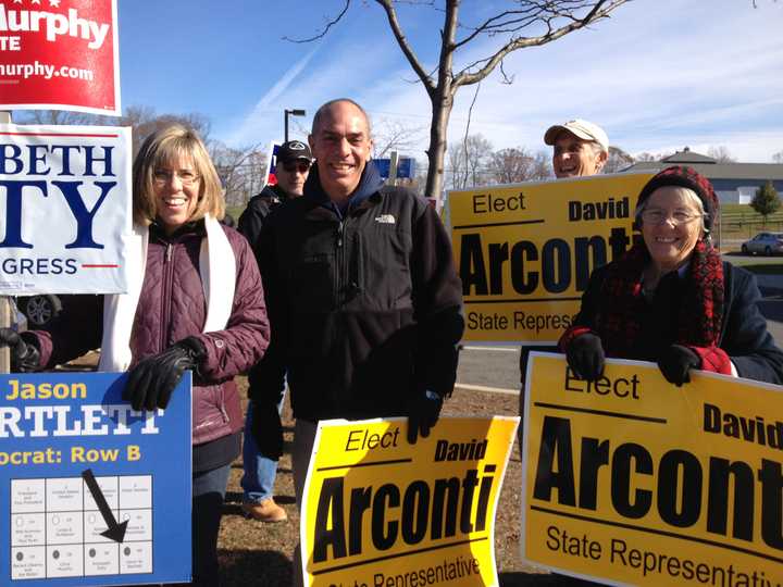 Lisa Arconti, David Arconti, Sr., Bob Taborsak and Lynn Taborsak hold political signs outside Broadview Middle School in Danbury as voters came to cast their ballots Tuesday.