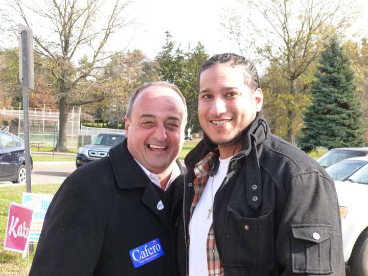 State Rep. Larry Cafero (R-142), right, greets Norwalk voter Patrick Ashman at the Fox Run polling site Tuesday. 