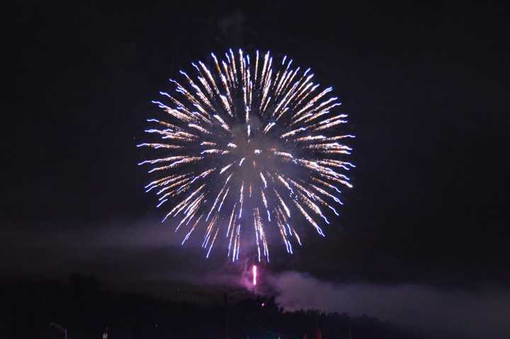 Fireworks explode above the Danbury Fair Mall and Danbury Airport on Thursday evening. 