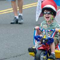 <p>A young boy is thrilled to be part of the Push-n-Pull Parade in Darien.</p>