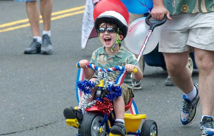 A young boy is thrilled to be part of the Push-n-Pull Parade in Darien.