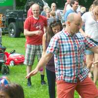 <p>A dad leads a dance line at Darien&#x27;s Fourth of July celebration at Tilley Pond Park.</p>